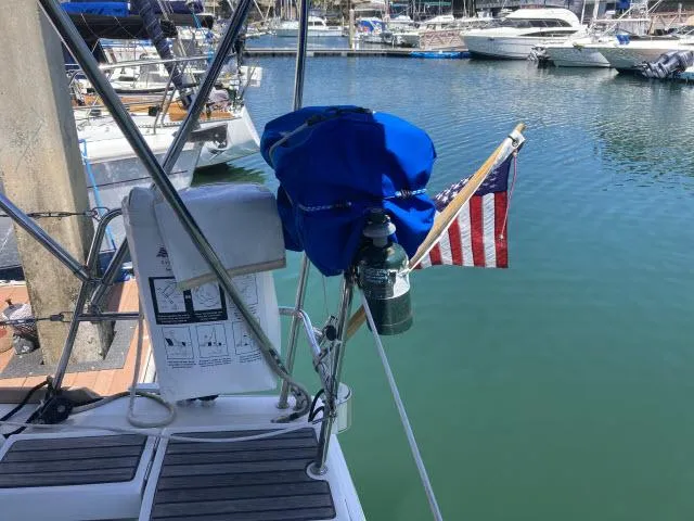 Slide: The Image of Beneteau Oceanis 45 (2014) sailboat docked at marina with American flag. - 36