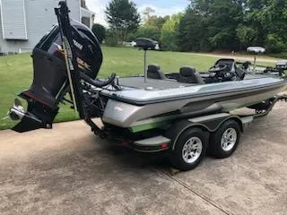 Slide: The Image of 2018 Skeeter ZX200 bass boat with outboard motor on trailer in driveway. - 3