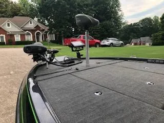 Slide: The Image of 2018 Skeeter ZX200 boat with mounted fishing equipment in a residential driveway. - 5