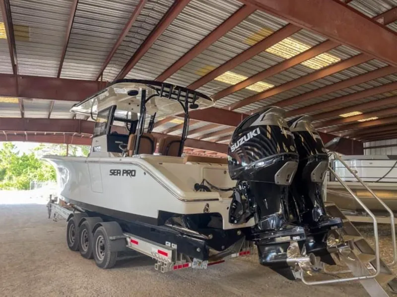Slide: The Image of 2025 Sea Pro 322 Offshore boat with dual Suzuki engines on a trailer. - 3