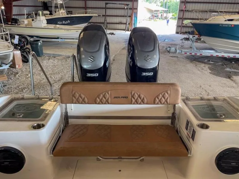 Slide: The Image of 2025 Sea Pro 322 Offshore boat with twin Suzuki 350 engines in a storage facility. - 8