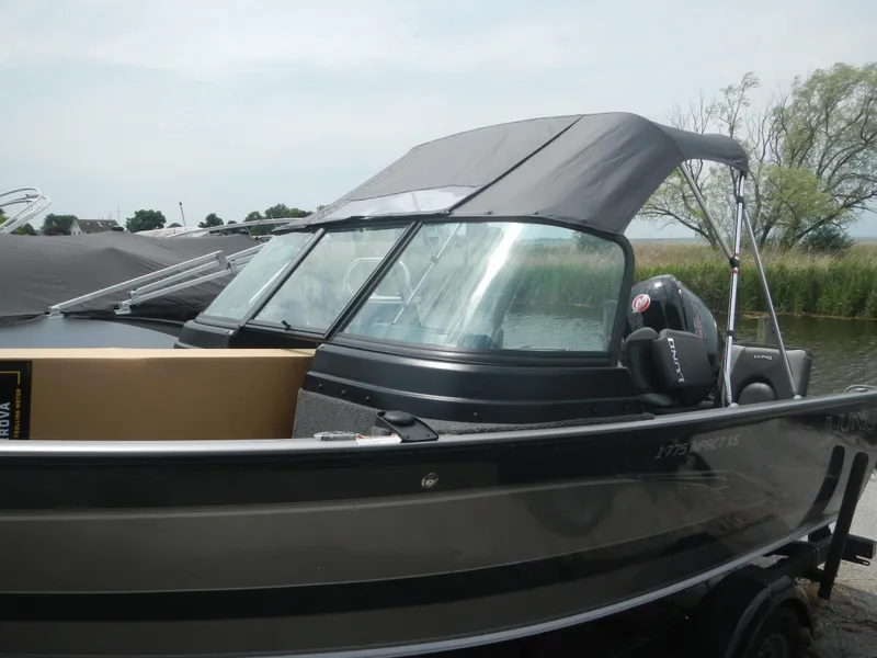 Slide: The Image of 2024 Lund 1775 Impact XS Sport boat with canopy on a trailer. - 10