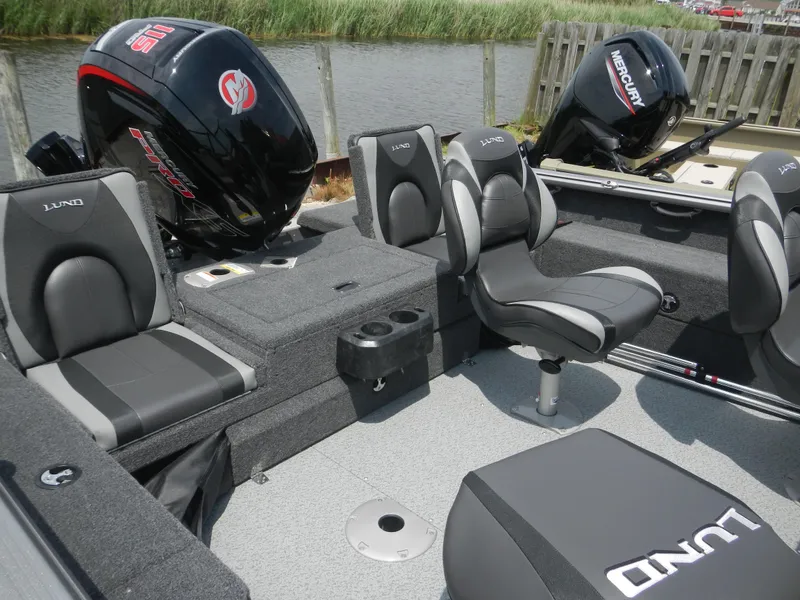 Slide: The Image of 2024 Lund 1775 Impact XS Sport boat interior with seating and Mercury outboard motor. - 4