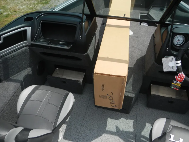 Slide: The Image of 2024 Lund 1775 Impact XS Sport boat interior with cardboard box. - 7