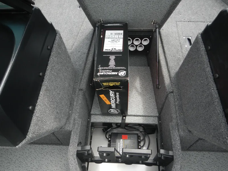Slide: The Image of 2024 Lund 1775 Impact XS Sport boat interior storage compartment with Mercury Marine battery. - 8