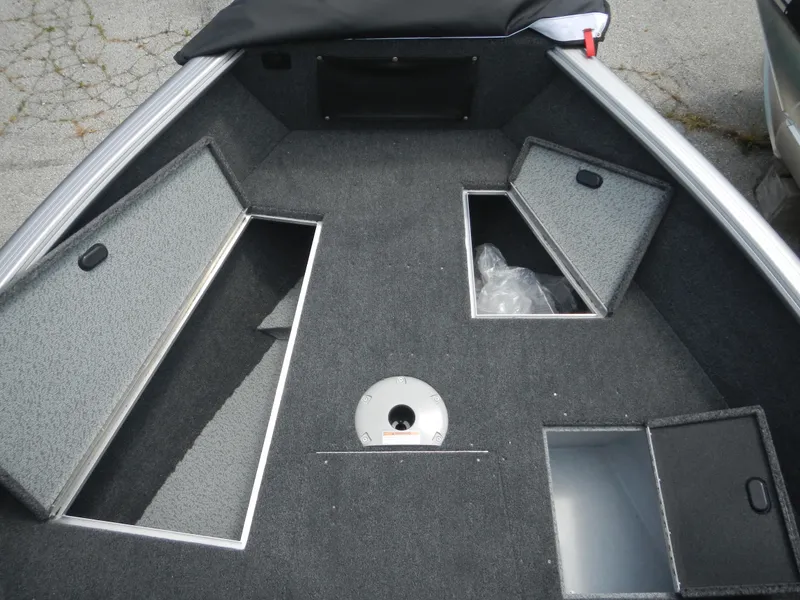 Slide: The Image of 2024 Lund 1775 Impact XS Sport boat interior with open storage compartments. - 9