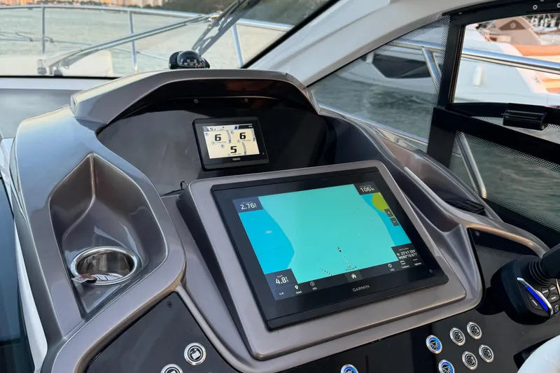 Slide: The Image of 2024 Sessa Marine C36 OB dashboard with navigation display and controls. - 13