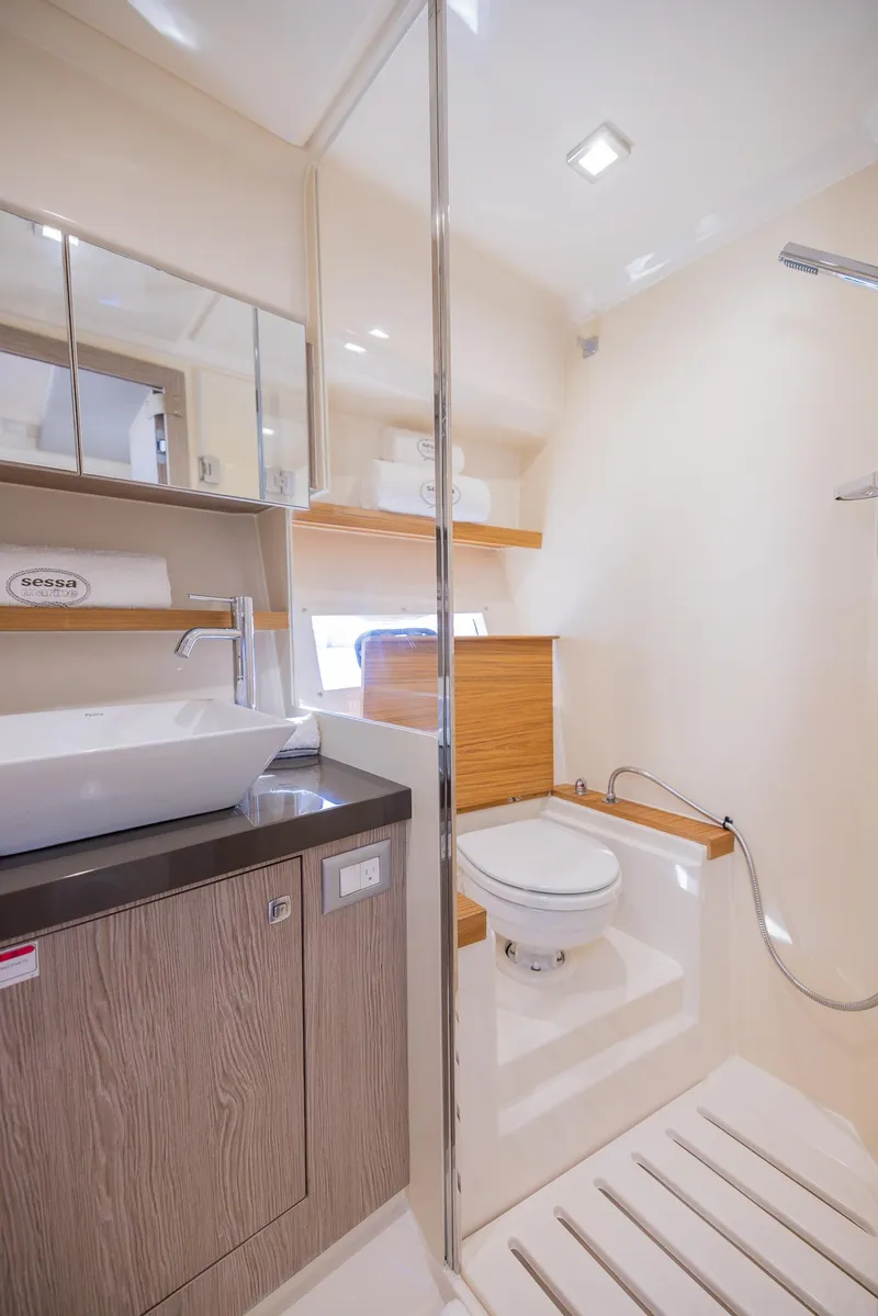 Slide: The Image of 2024 Sessa Marine C36 OB yacht bathroom with modern fixtures and wood accents. - 30