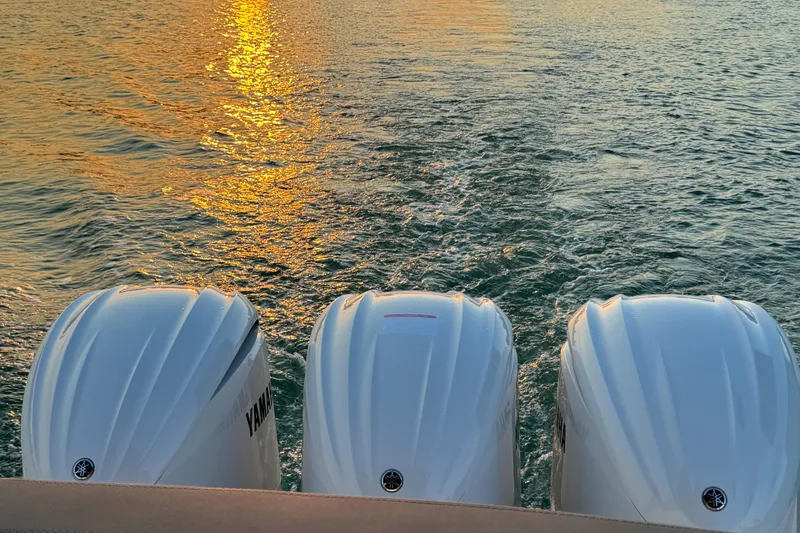 Slide: The Image of 2024 Sessa Marine C36 OB with triple outboard engines at sunset on the water. - 7