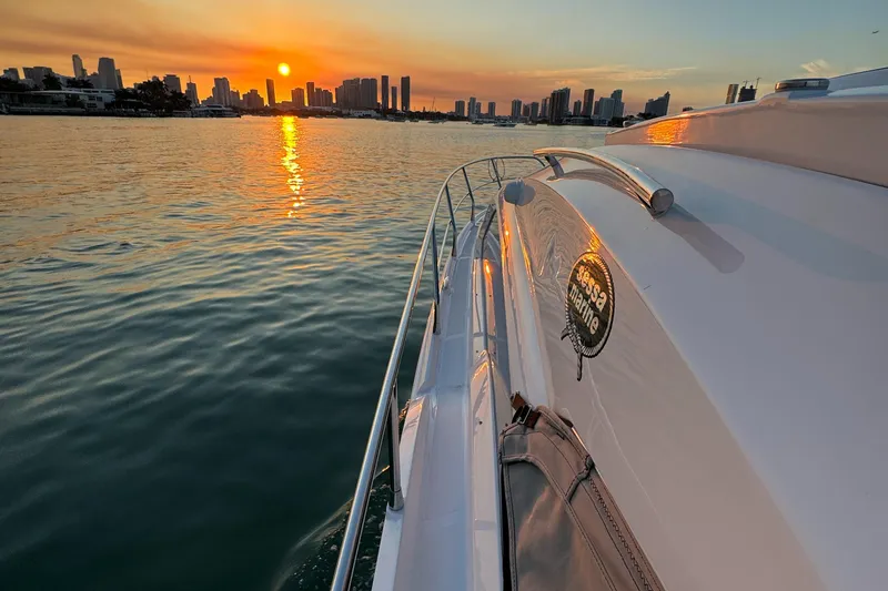 Slide: The Image of Sessa Marine C36 OB 2024 cruising at sunset near city skyline. - 10