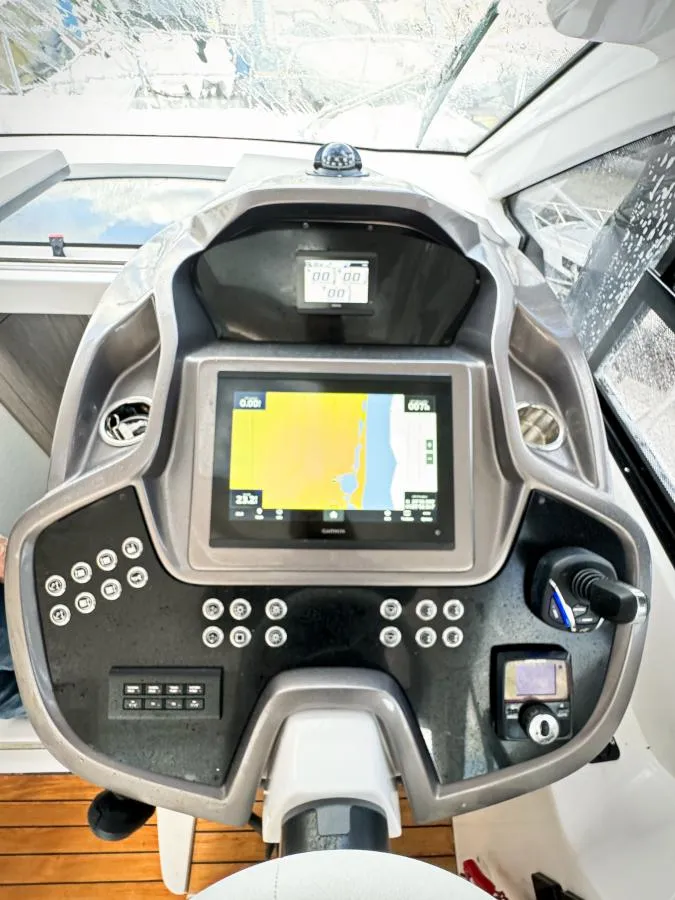 Slide: The Image of 2024 Sessa Marine C36 OB dashboard with navigation display and controls. - 14