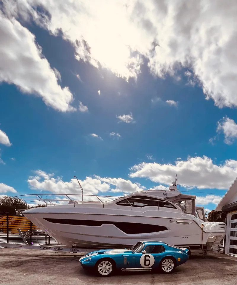Slide: The Image of 2024 Sessa Marine C36 OB yacht under a bright blue sky with clouds. - 2