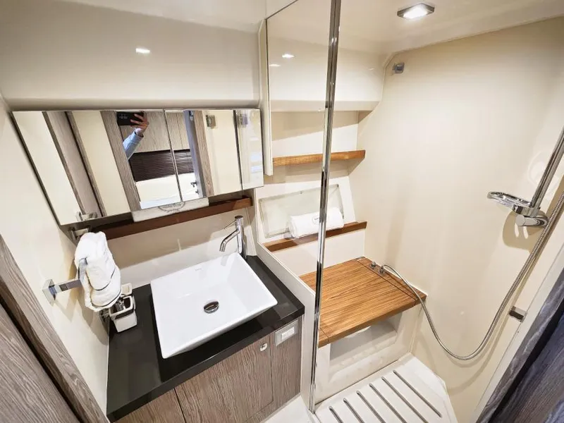 Slide: The Image of Luxurious bathroom in 2024 Sessa Marine C36 OB yacht with modern fixtures and wooden accents. - 25