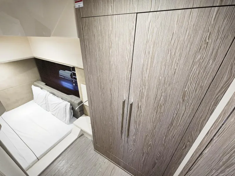 Slide: The Image of 2024 Sessa Marine C36 OB cabin interior with modern wood finish and cozy bed. - 26