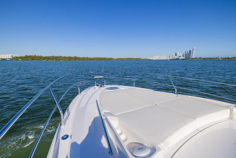 Slide: The Image of 2024 Sessa Marine C36 OB yacht cruising on a sunny day with city skyline view. - 7