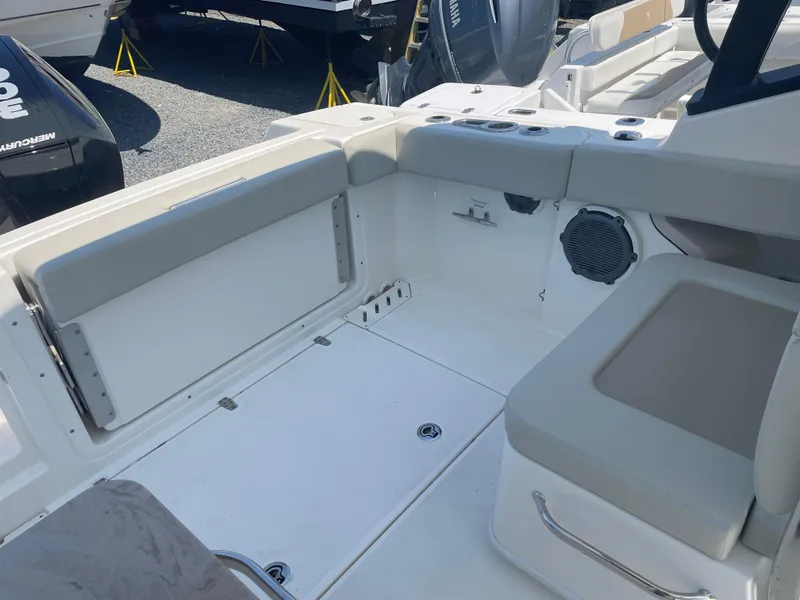 Slide: The Image of 2023 Boston Whaler 240 Vantage boat interior with seating and storage compartments. - 11