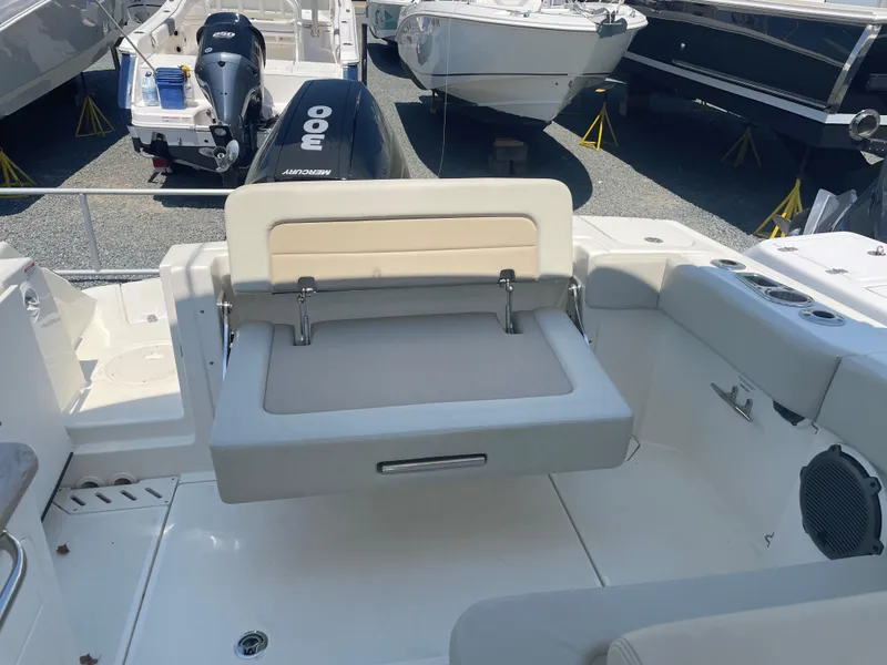 Slide: The Image of 2023 Boston Whaler 240 Vantage boat interior with foldable seating and outboard motor. - 12