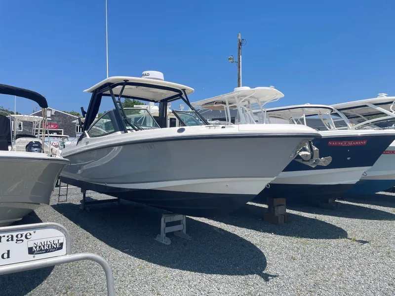 Slide: The Image of 2023 Boston Whaler 240 Vantage boat displayed on gravel lot. - 2