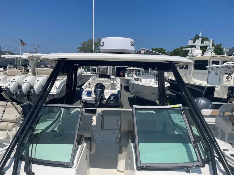 Slide: The Image of 2023 Boston Whaler 240 Vantage boat at a marina, front view. - 4