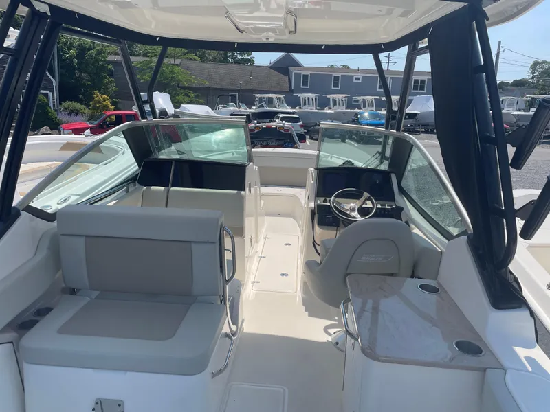 Slide: The Image of 2023 Boston Whaler 240 Vantage boat interior with seating and steering console. - 5
