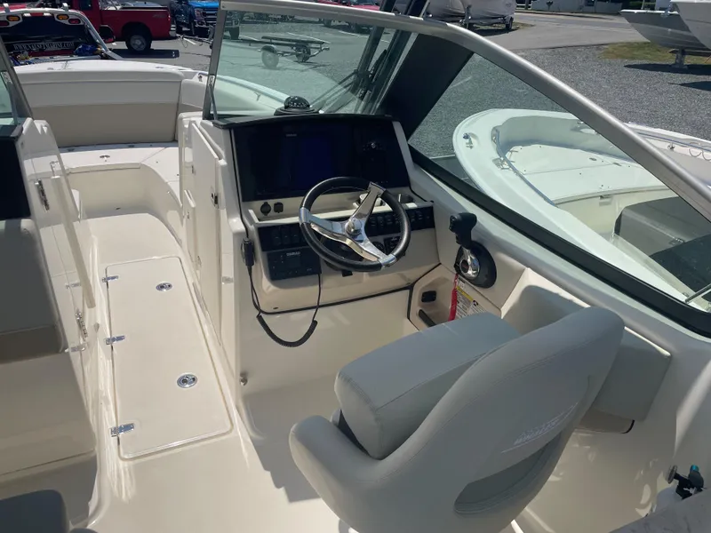 Slide: The Image of 2023 Boston Whaler 240 Vantage boat interior with helm station and seating. - 6