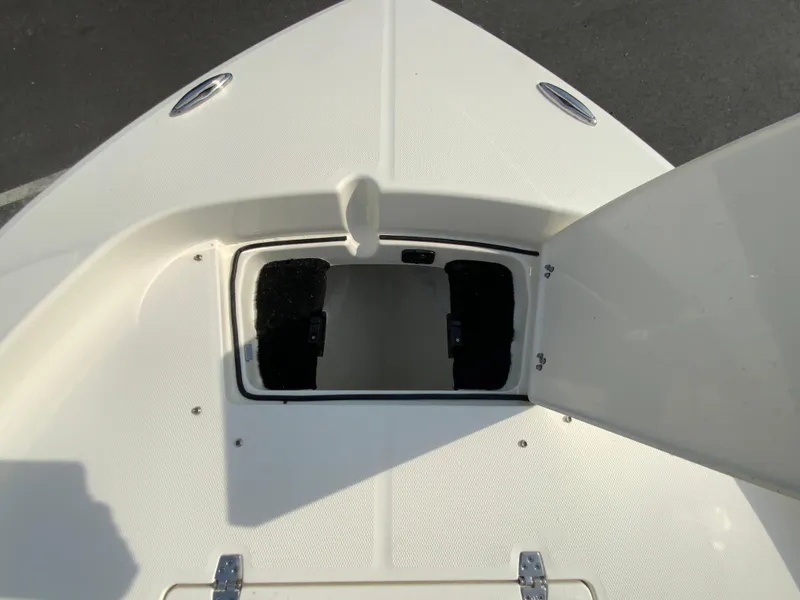 Slide: The Image of 2024 Pathfinder 2200 TRS boat storage compartment with open hatch. - 12