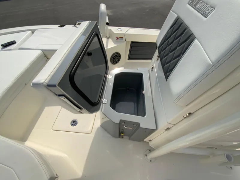 Slide: The Image of 2024 Pathfinder 2200 TRS boat interior with open storage compartment and cushioned seating. - 21
