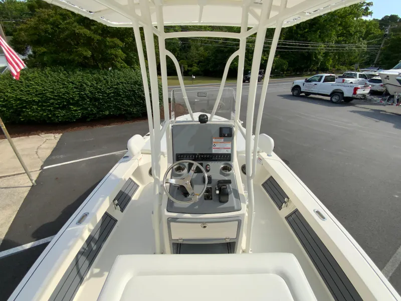 Slide: The Image of 2024 Pathfinder 2200 TRS boat interior with steering console and seating. - 24