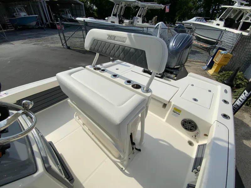 Slide: The Image of 2024 Pathfinder 2200 TRS boat interior with white seating and Yamaha outboard motor. - 27