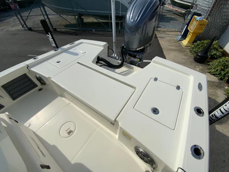 Slide: The Image of 2024 Pathfinder 2200 TRS boat stern with outboard motor and storage compartments. - 29