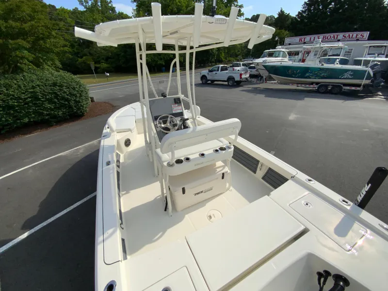 Slide: The Image of 2024 Pathfinder 2200 TRS boat with center console and T-top in a dealership lot. - 30