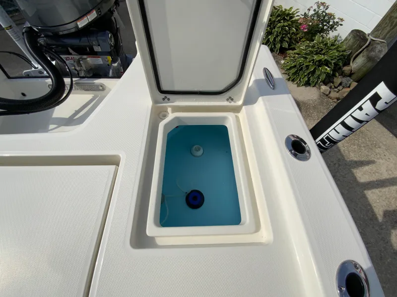 Slide: The Image of 2024 Pathfinder 2200 TRS boat livewell with open lid, showing blue interior. - 32