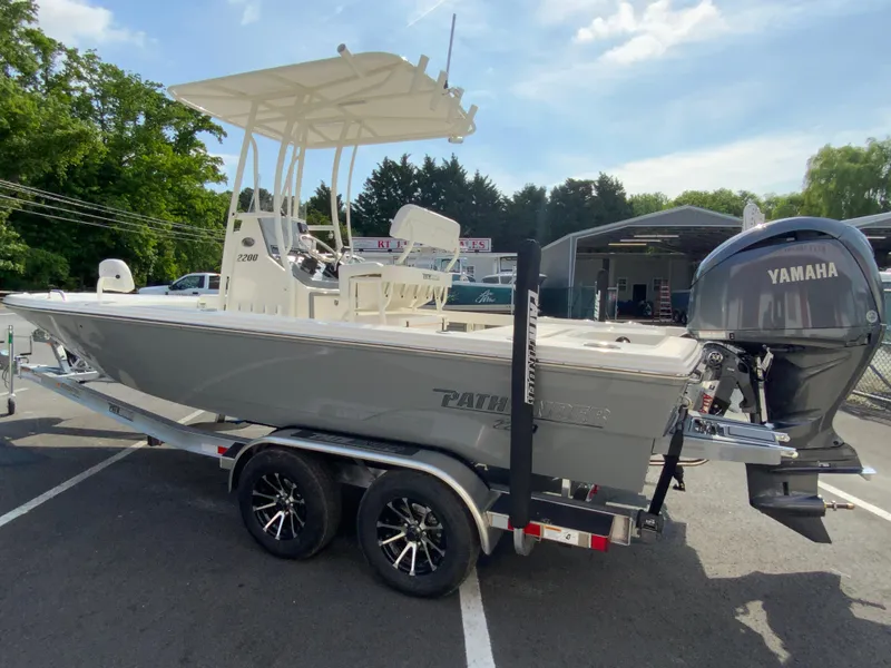 Slide: The Image of 2024 Pathfinder 2200 TRS boat on trailer with Yamaha outboard motor. - 7
