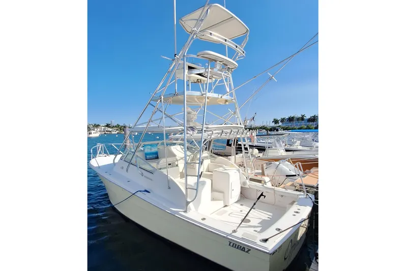 Slide: The Image of 2001 Topaz Express boat docked at marina under clear blue sky. - 1
