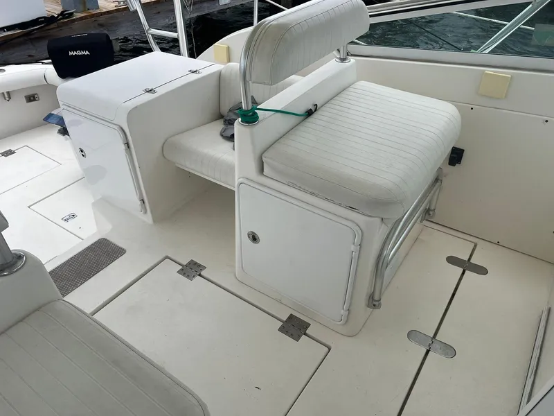 Slide: The Image of 2001 Topaz Express boat interior with white seating and storage compartments. - 10