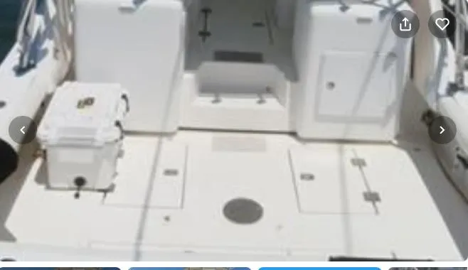 Slide: The Image of 2001 Topaz Express boat deck with storage compartments and cooler. - 11