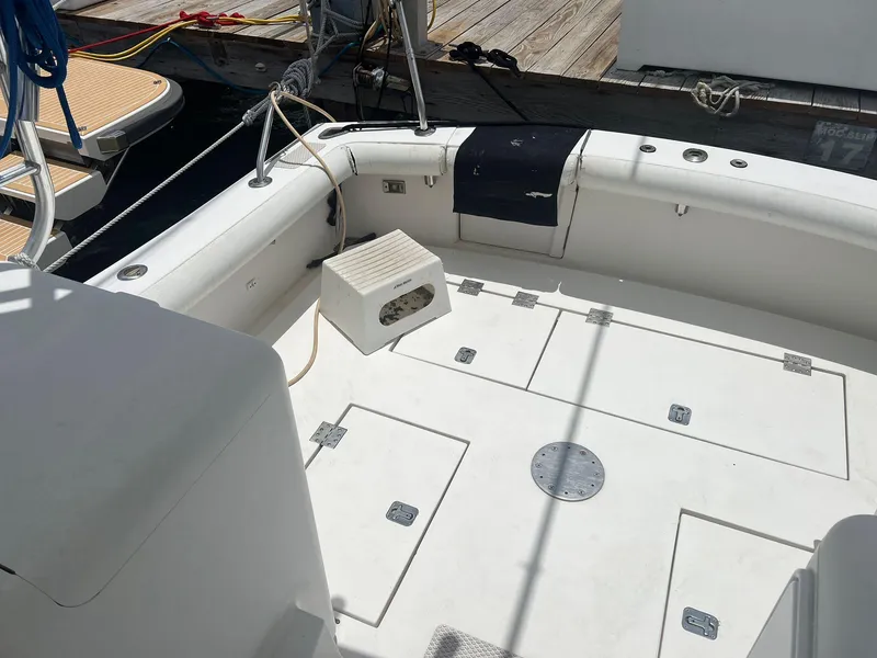 Slide: The Image of 2001 Topaz Express boat deck with storage compartments and seating. - 14