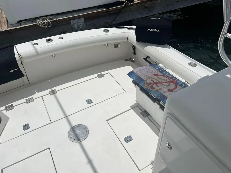 Slide: The Image of Spacious deck of a 2001 Topaz Express boat with seating and storage. - 15