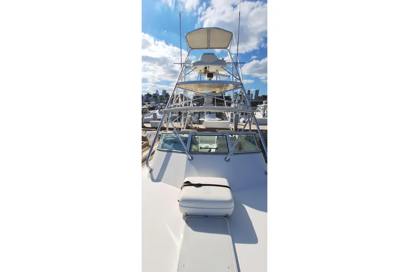 Slide: The Image of 2001 Topaz Express boat with tower against a blue sky and marina backdrop. - 18