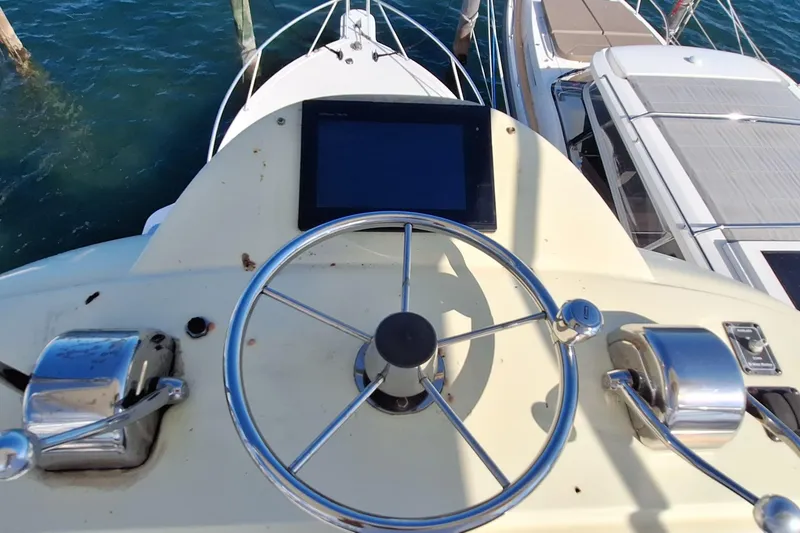 Slide: The Image of Helm of a 2001 Topaz Express boat with steering wheel and controls. - 20