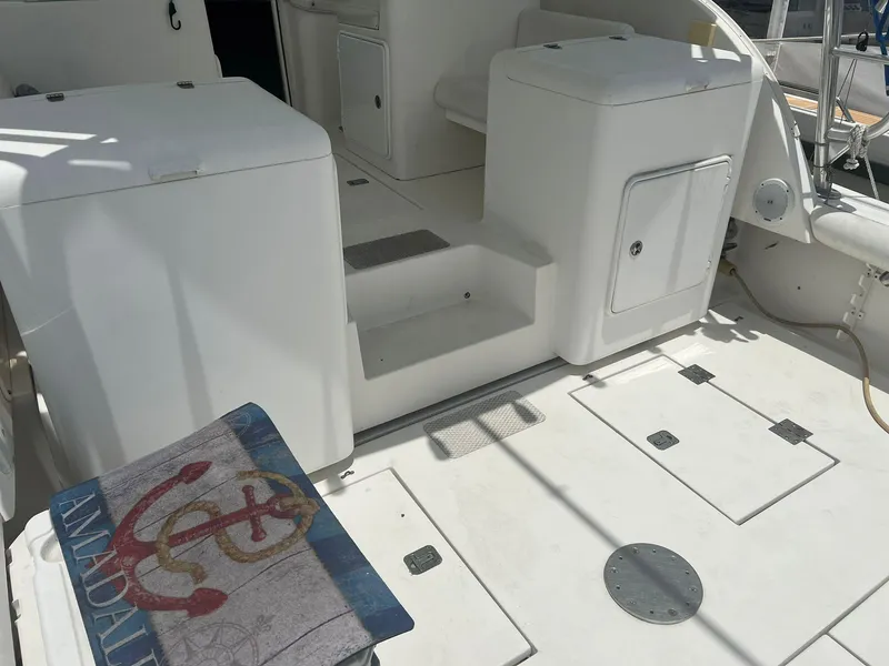 Slide: The Image of Interior of a 2001 Topaz Express boat, featuring white seating and storage compartments. - 27