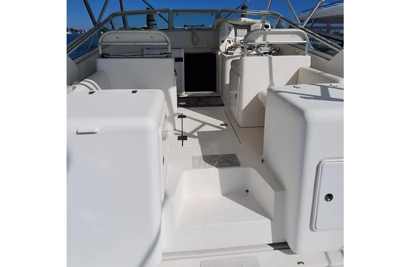 Slide: The Image of 2001 Topaz Express boat interior with white seating and steering area. - 28