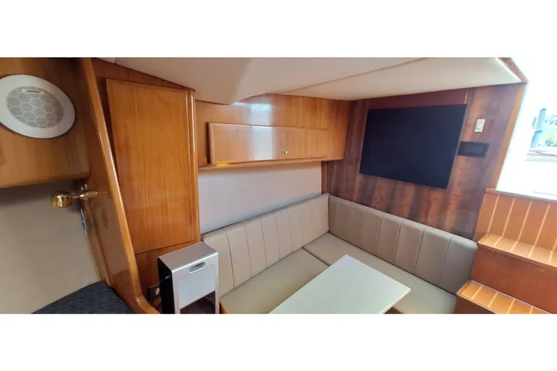 Slide: The Image of 2001 Topaz Express boat interior with wood paneling and cushioned seating area. - 30