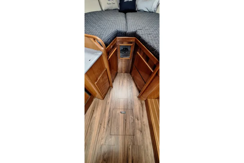 Slide: The Image of Interior of 2001 Topaz Express with wood flooring and cozy bedding. - 37