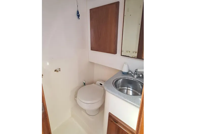 Slide: The Image of Compact bathroom in 2001 Topaz Express boat with toilet and sink. - 38