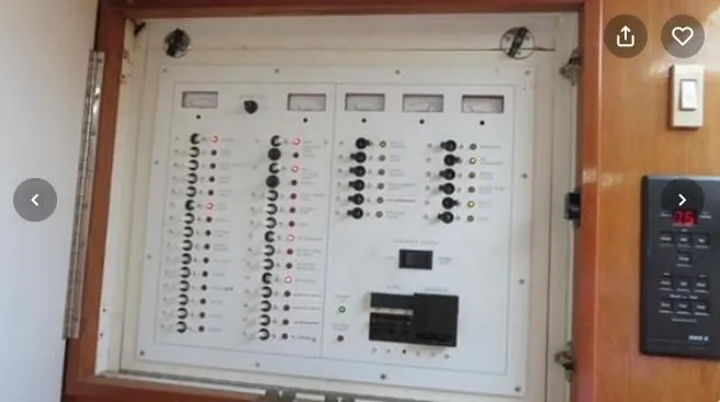 Slide: The Image of Electrical control panel on a 2001 Topaz Express boat, featuring multiple switches and meters. - 40