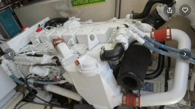 Slide: The Image of Engine of a 2001 Topaz Express boat, featuring white and black components. - 41