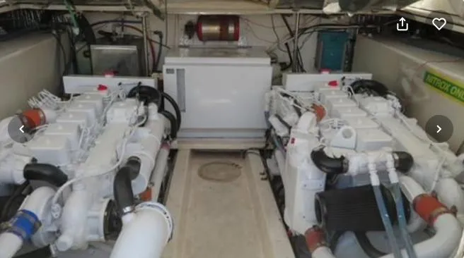 Slide: The Image of Engine room of a 2001 Topaz Express boat, featuring dual engines and mechanical components. - 42