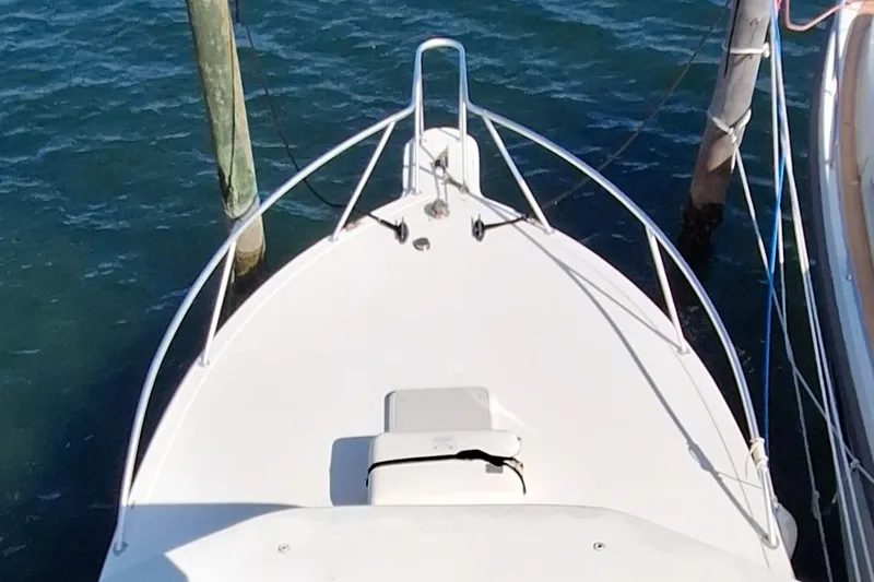 Slide: The Image of Bow of 2001 Topaz Express boat docked on calm water. - 5