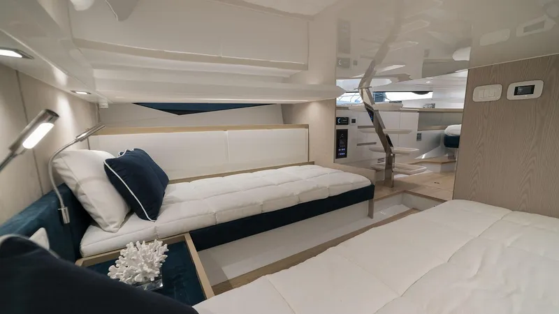 Slide: The Image of Interior of 2025 Fiart 35 Seawalker yacht with modern, luxurious white and navy decor. - 12